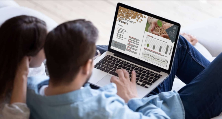Couple browses Hargassner's brochure on a laptop | Hargassner