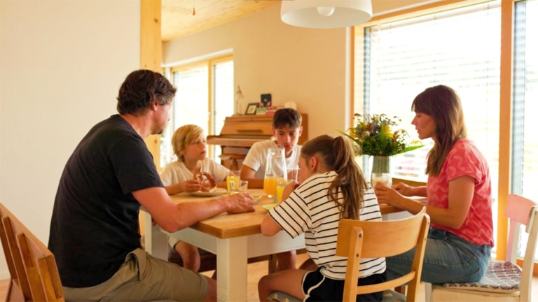 Eine Familie frühstückt in ihrem mit Pellets beheizten Haus | Hargassner