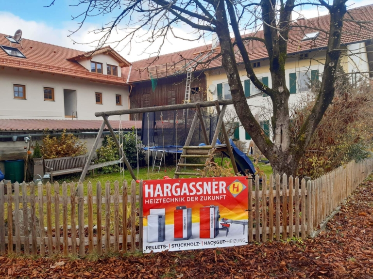 Hargassner Werbebanner im Hinterhof der Familie Breu | Hargassner