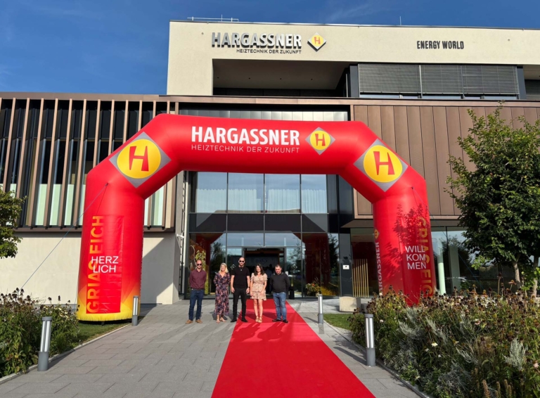 The UK team at the entrance of Hargassner's headquarters in Austria, heading to the 40th-anniversary in-house exhibition.