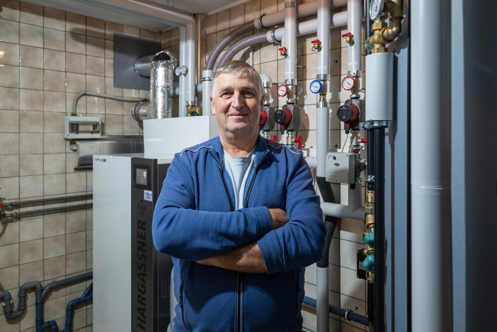 Customer Manfred Heizinger in front of his new Nano-PK pellet heating system | Reference Hargassner