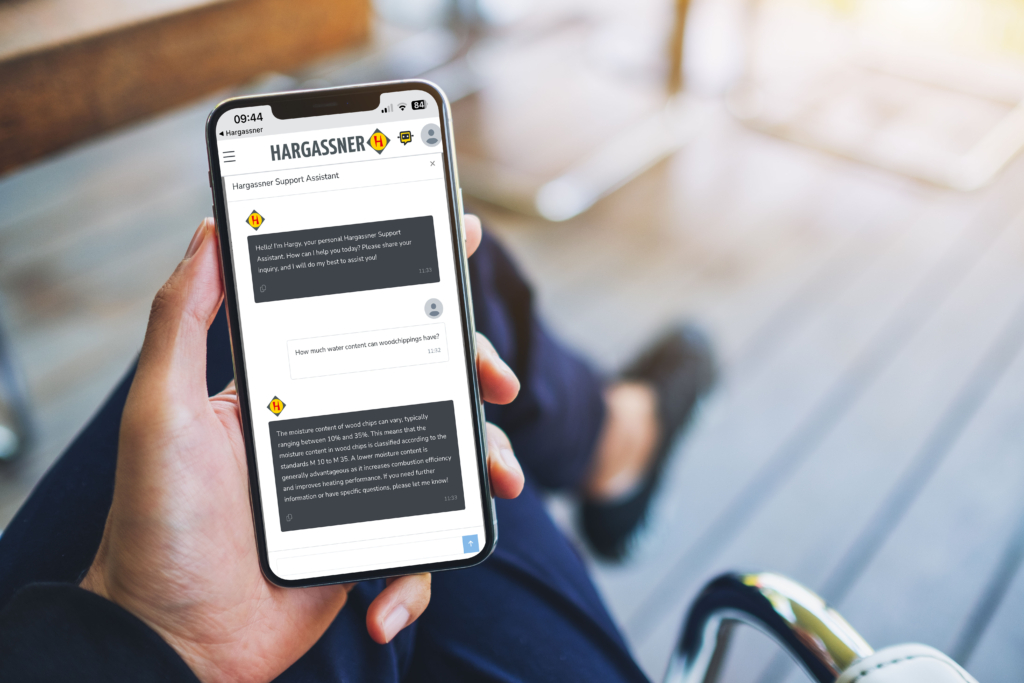 Man holding cell phone and chatting with Hargy AI support assistant