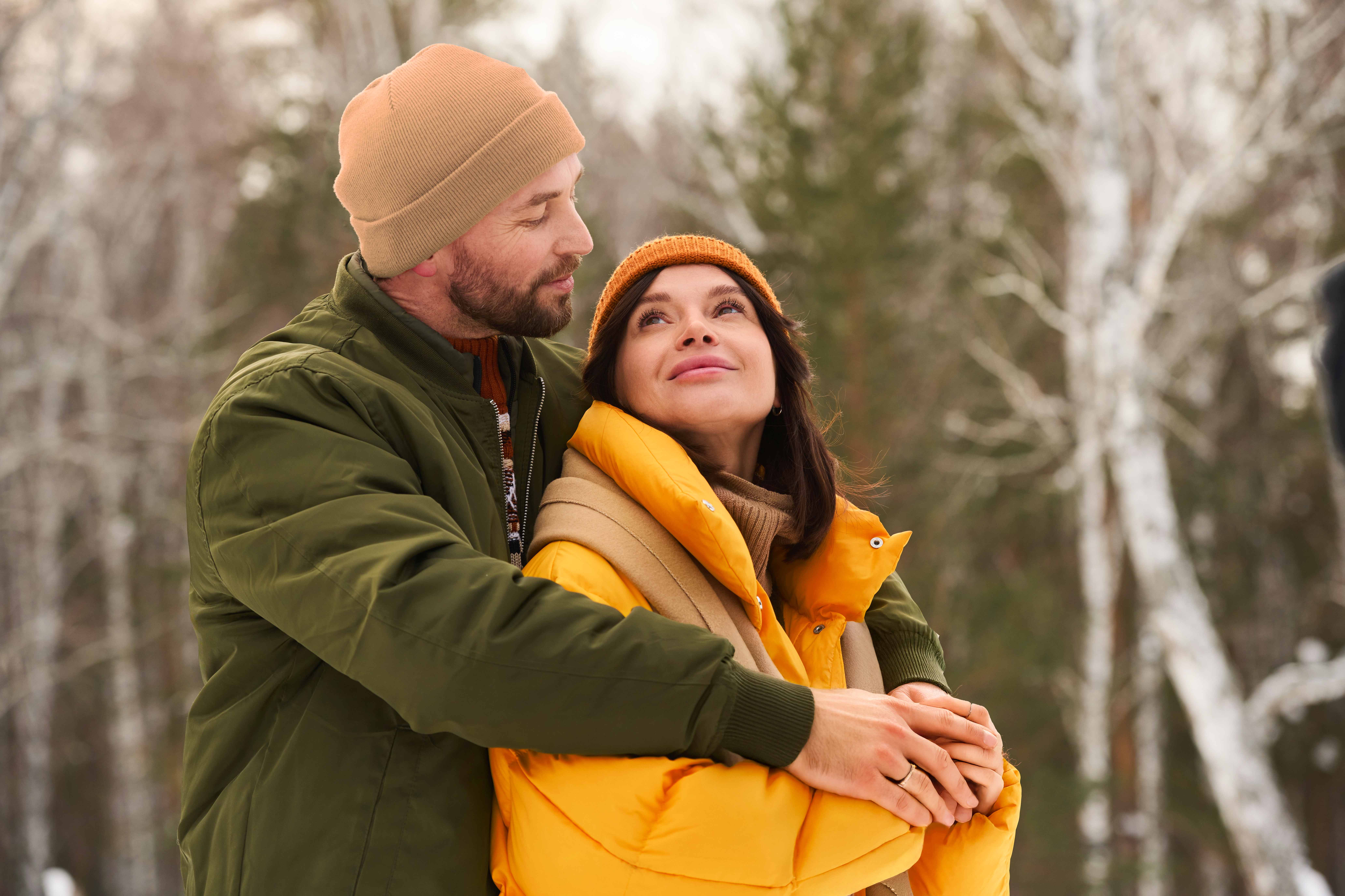 Paar umamrt sich in winterlicher Landschaft