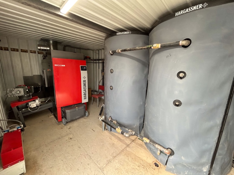 Interior view of heating container, boiler room with wood chip boiler Eco-HK 330 and accumulator tanks - Reference municipality Saint-Cléophas, Quebec