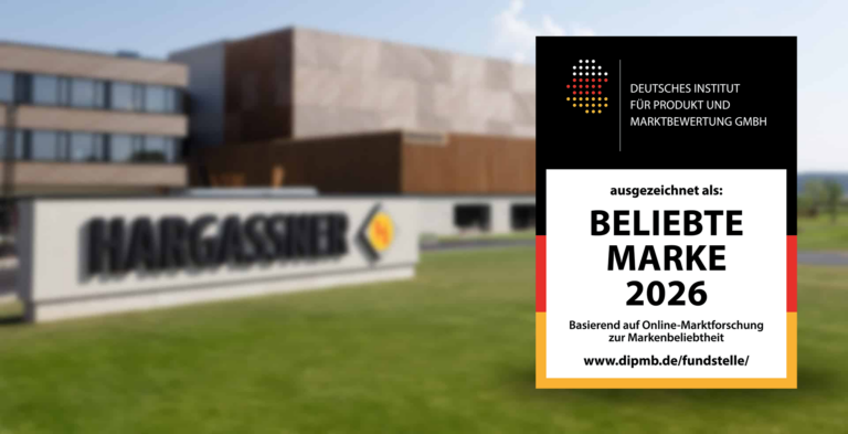 Das Gütesiegel "Beliebte Marke 2026" vor dem Hargassner-Firmengebäude